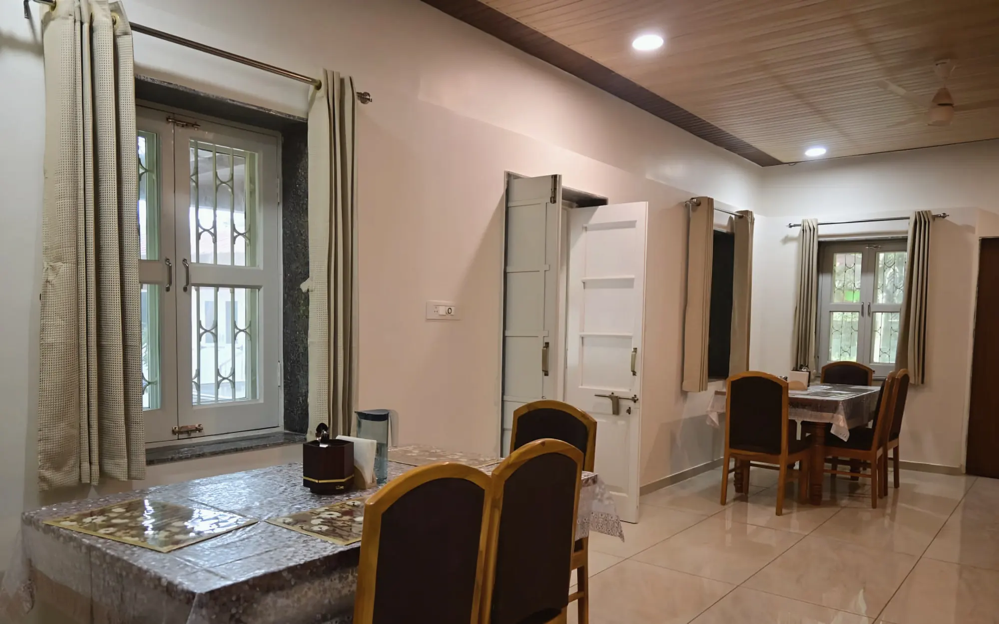 Dining tables in the hall by the windows